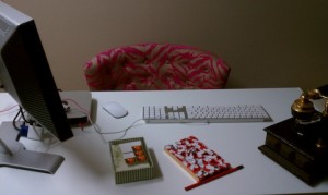 Glossy white desktop with pink zebra print office chair adds to the glamour